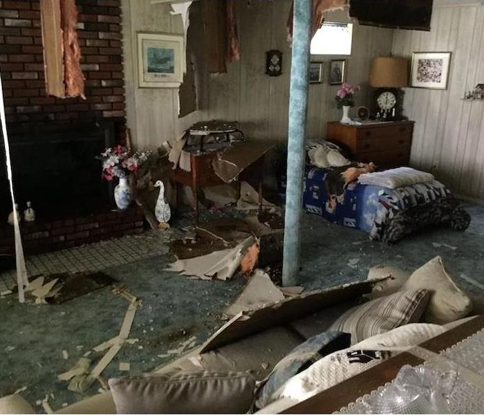 Cluttered room with fireplace and debris on floor