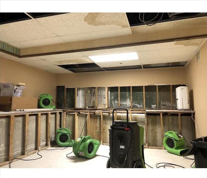Room with exposed framework and SERVPRO equipment