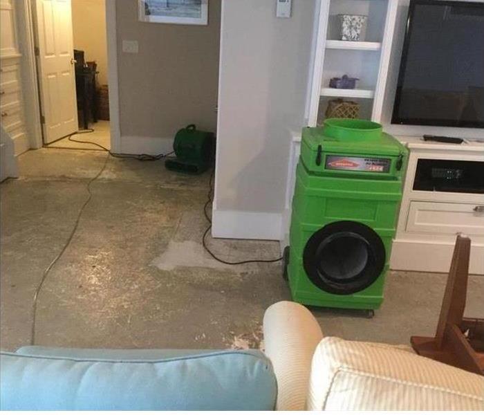 One of our green machines extracting water from the wet carpet in this home