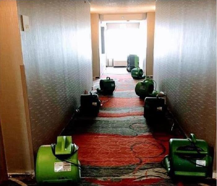 WATER SOAKED, CARPETED HALLWAY IN A HOTEL